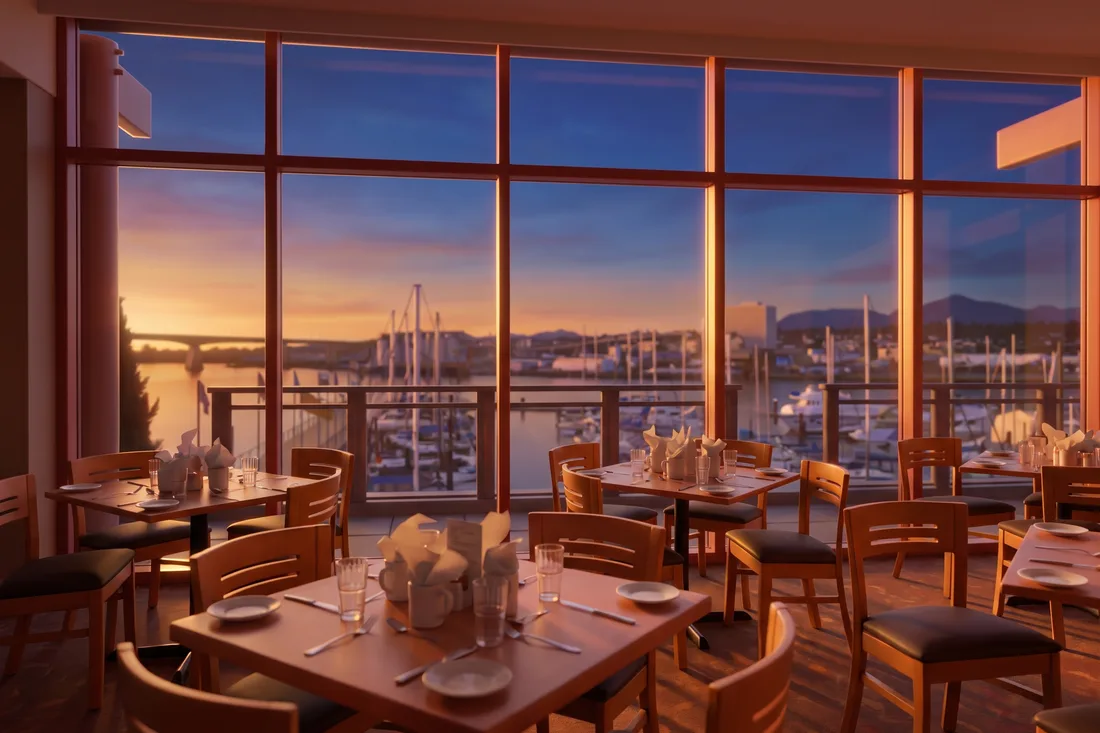 Restaurant tables at River Rock by a window on the marina
